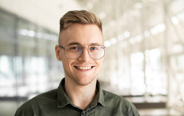 cheerful caucasian young man entrepreneur in office building close up